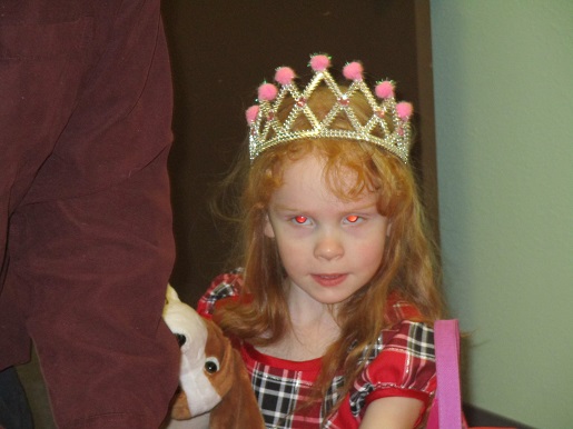 A little girl wearing a crown